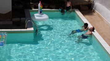 Swimmers can enjoy a refreshing dip in the pool surrounded by a simple, functional design.