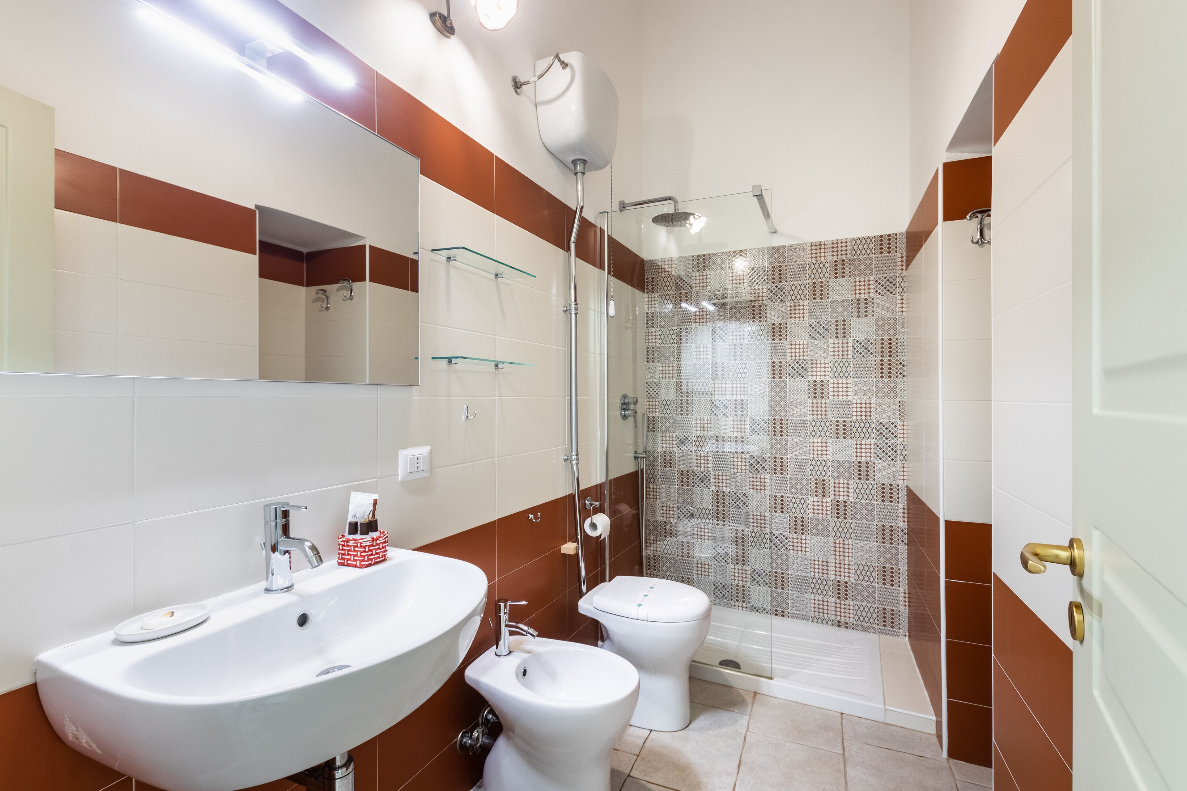 A bathroom with a sink, toilet, and shower area.