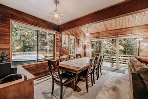 Relax in this inviting space with a dining table, hot tub, and comfortable seating areas.