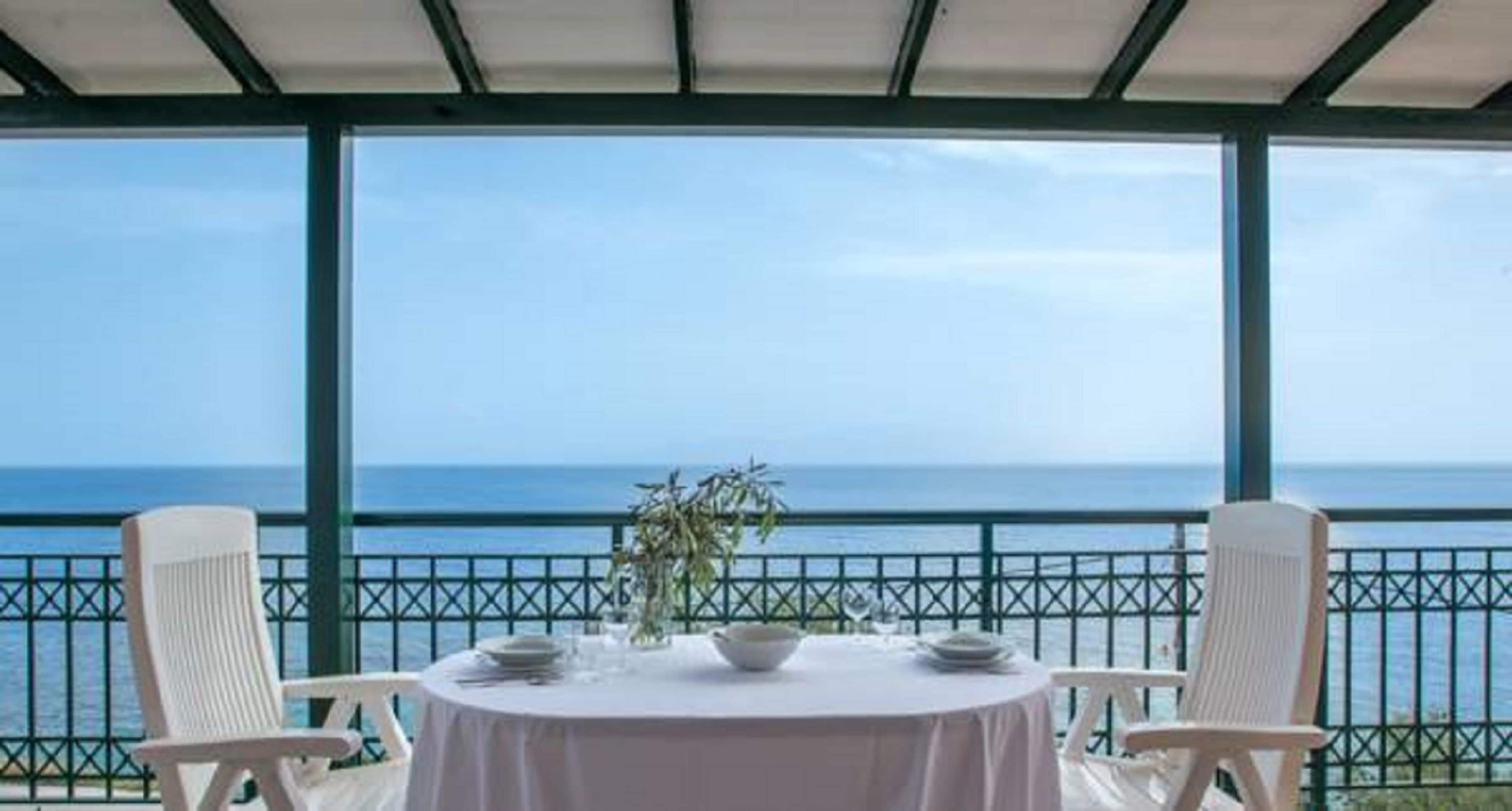 A table set for two with a view of the sea.