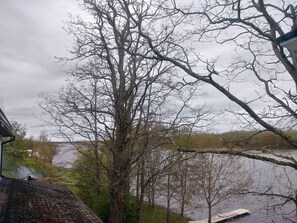 A view of a lake with trees and a dock.