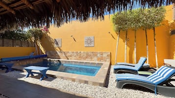 Outdoor pool, a heated pool, open 9:00 AM to 8:00 PM, pool loungers