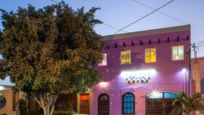 A building with a purple facade, a large tree in front, and a sign that reads "Casa de la Cultura." - B&B Casa Juarez (La Paz)