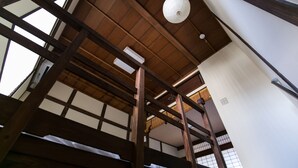 A traditional Japanese room with wooden beams, tatami flooring, and a shoji screen. - KYOTO yadomachi Kamishichiken (Kyoto)
