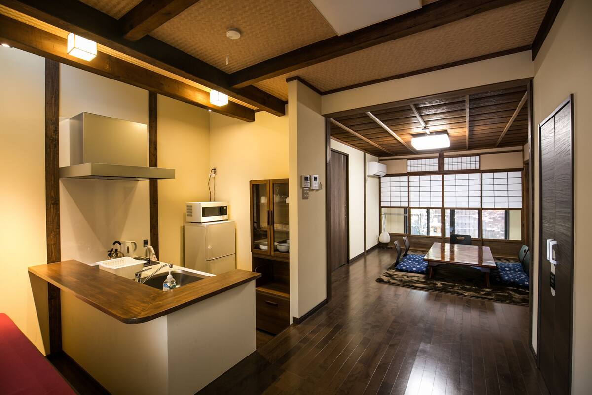 A modern kitchen with a wooden countertop, built-in microwave, and a sink.