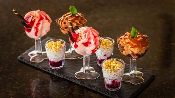 Four dessert cups on a slate serving board.