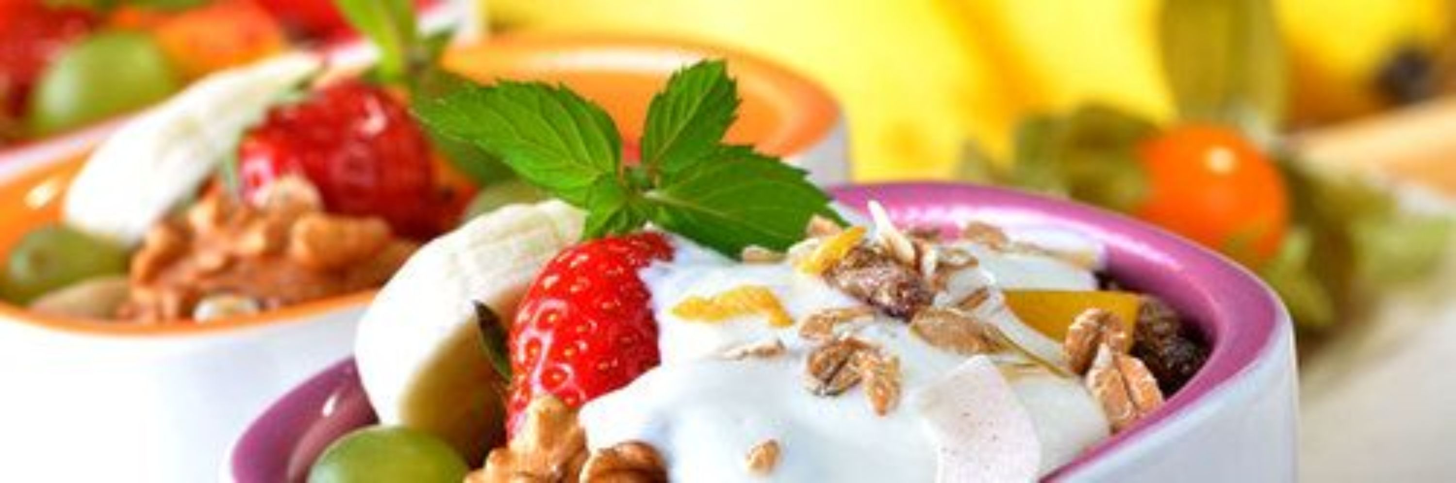 A dessert with strawberries, yogurt, and granola.