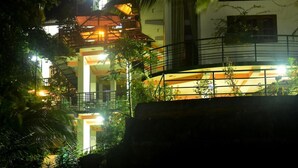 A multi-story building with a balcony and a staircase. - Rainforest Lodge (Deniyaya)