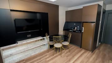 Deluxe Suite, 2 Bedrooms, Jetted Tub | Living area | 55-inch LCD TV with satellite channels, TV