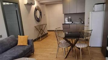 Two-Bedroom Suite | Living area | 55-inch LCD TV with satellite channels, TV