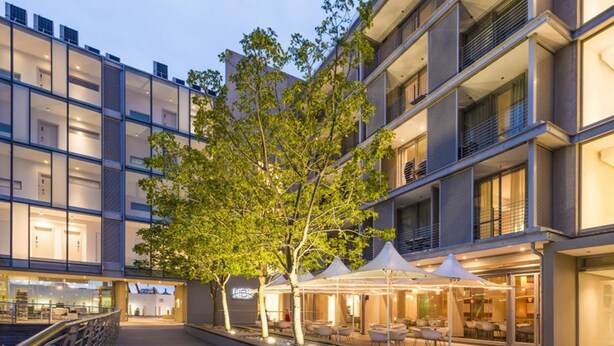 A modern hotel with a courtyard, outdoor seating, and a pool. - 410 Harbour Bridge (Cape Town)