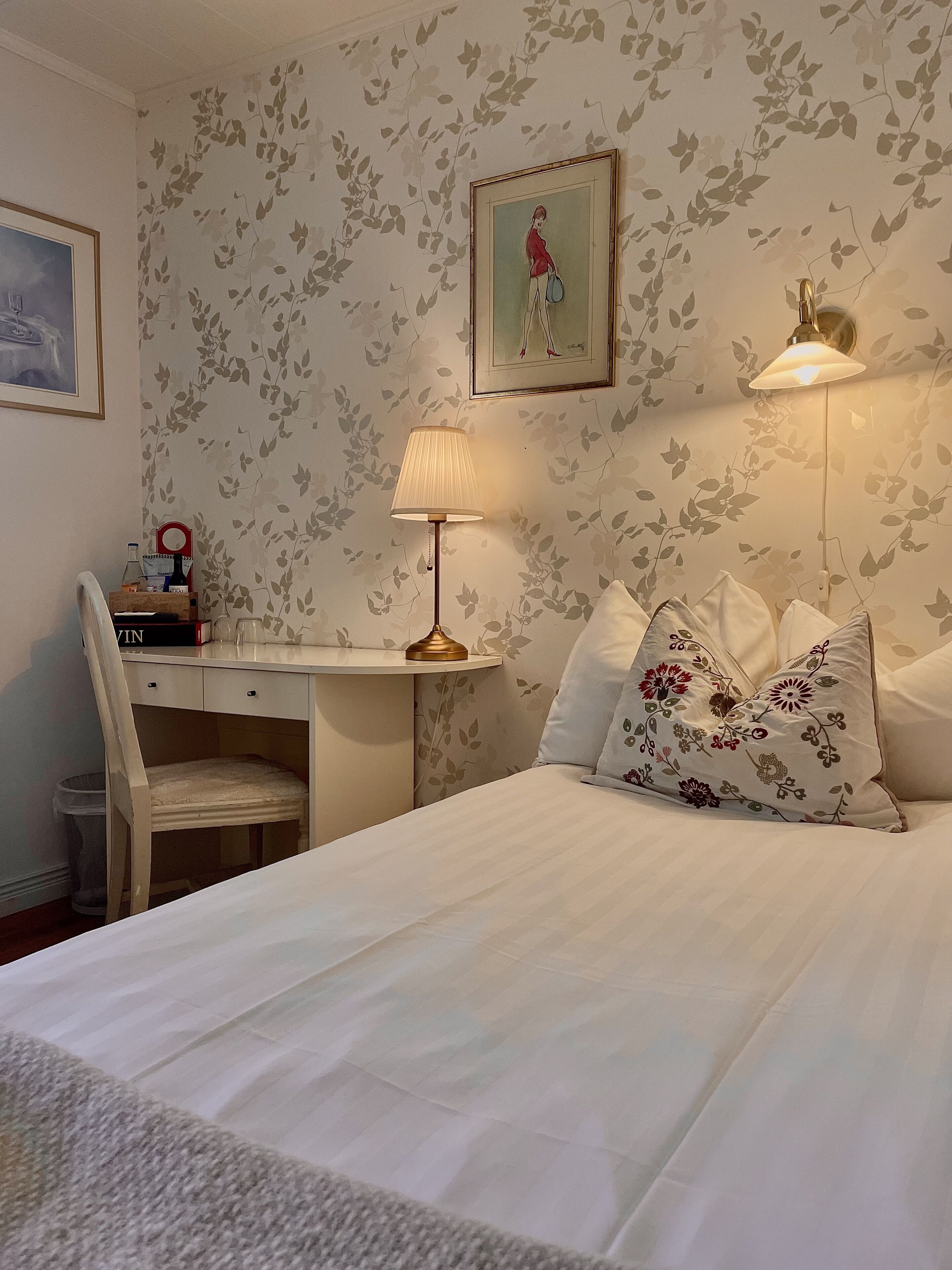 A neatly arranged bedroom with a bed, a desk, and a chair.