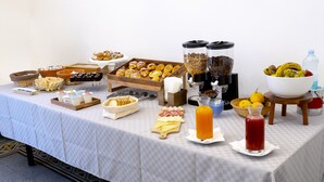 A buffet table with various food items, including pastries, cheeses, and beverages. - Principe di Belmonte (Palermo)