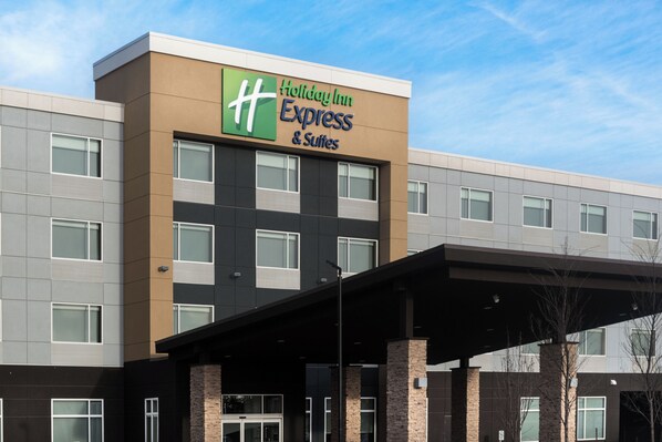 A Holiday Inn Express & Suites building with a modern design, featuring a prominent sign, a covered entrance, and multiple windows. - Holiday Inn Express & Suites West Edmonton - Mall Area by IHG (Edmonton)