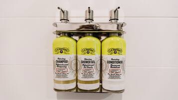 Three bottles of J.R. Walkins products on a metal rack.