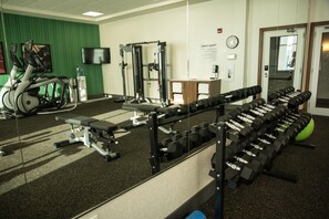 A gym with exercise equipment, a treadmill, and a mirror. - Holiday Inn Express & Suites West Edmonton - Mall Area by IHG (Edmonton)