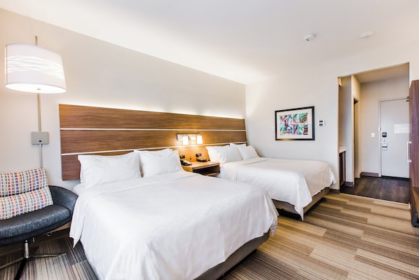 A hotel room with two beds, a sofa, a lamp, a nightstand, and a painting on the wall. - Holiday Inn Express & Suites West Edmonton - Mall Area by IHG (Edmonton)