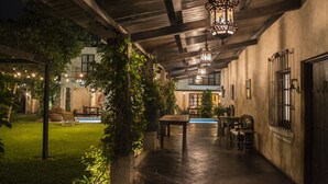 An indoor courtyard with a pool, wooden pergola, and hanging lanterns. - Hotel Casa San Lázaro (Antigua Guatemala)