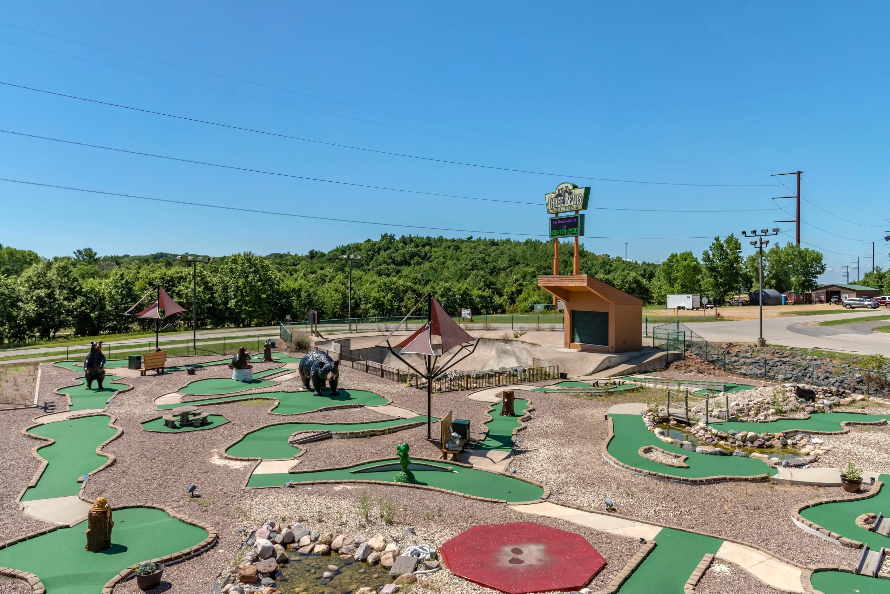 A miniature golf course with a sign reading "Three Bears."