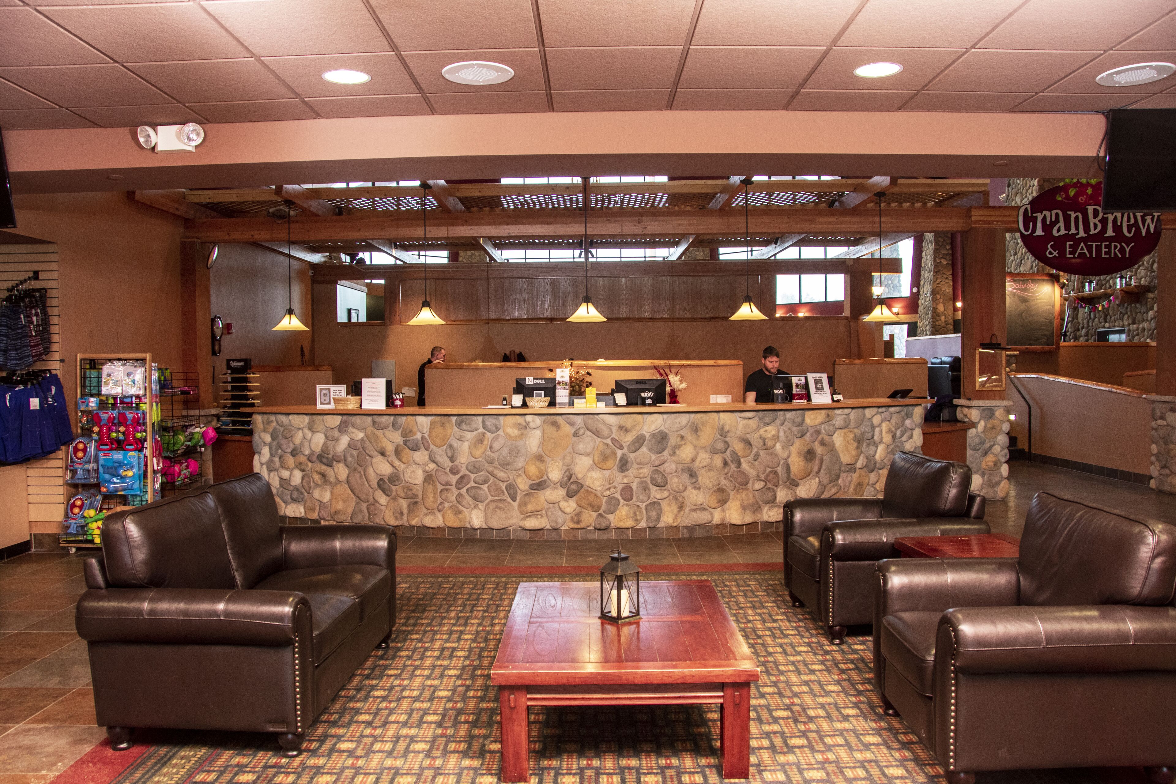 A restaurant interior with a stone counter, leather seating, and a patterned carpet.