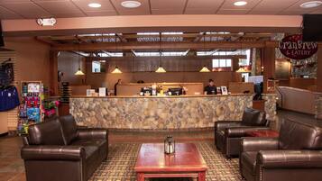 A restaurant interior with a stone counter, leather seating, and a patterned carpet.