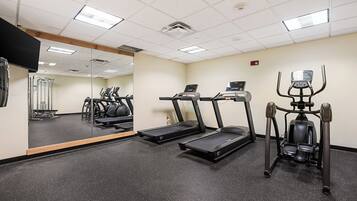 A gym with treadmills, a stationary bike, and a mirror.