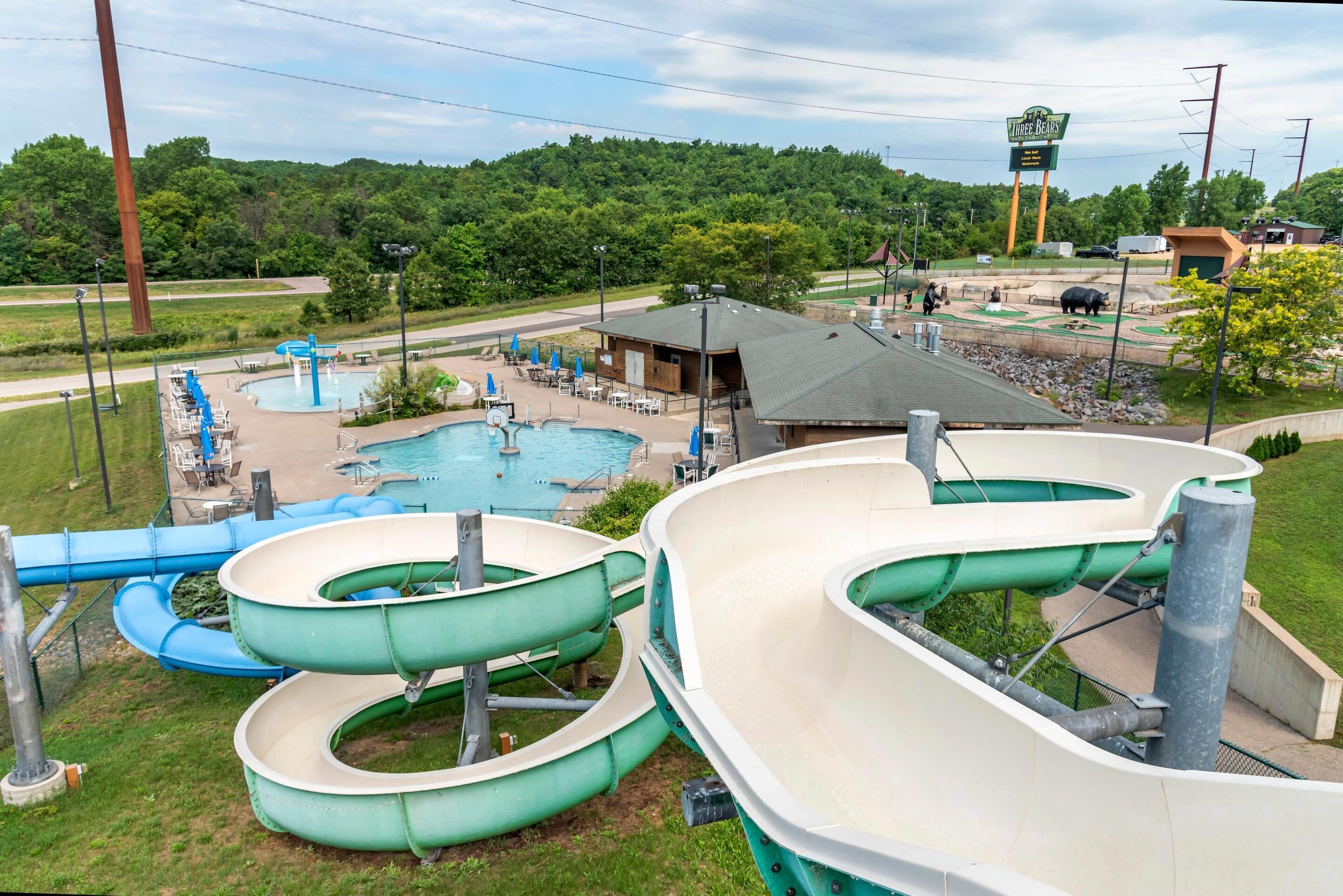 A water park with multiple slides and a pool area.