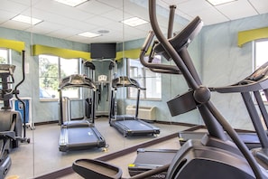 A gym with treadmills, elliptical machines, and a stationary bike. - Suburban Studios Donaldsonville - Gonzales (Donaldsonville)