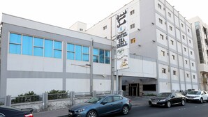 A modern building with a large sign for Hotel Sea Shell. It has multiple floors and a prominent entrance. - Sea Shell Hotel (Manama)