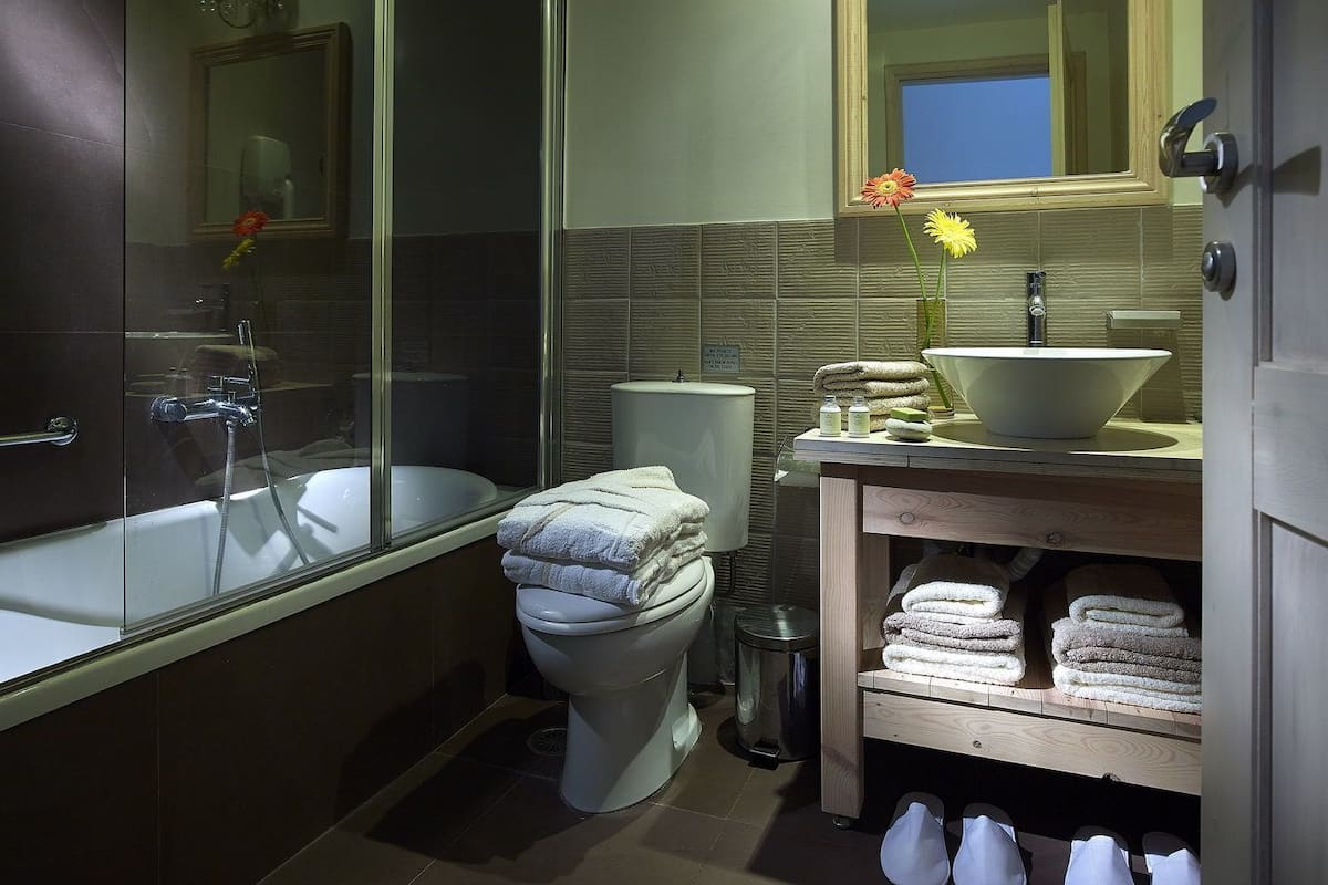 suite | bathroom | designer toiletries, hair dryer, slippers
