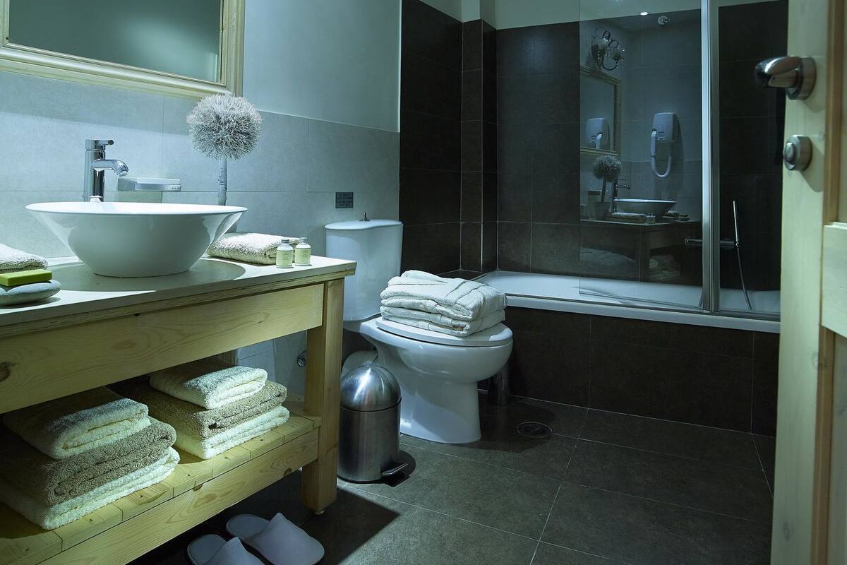 family suite | bathroom | designer toiletries, hair dryer, slippers