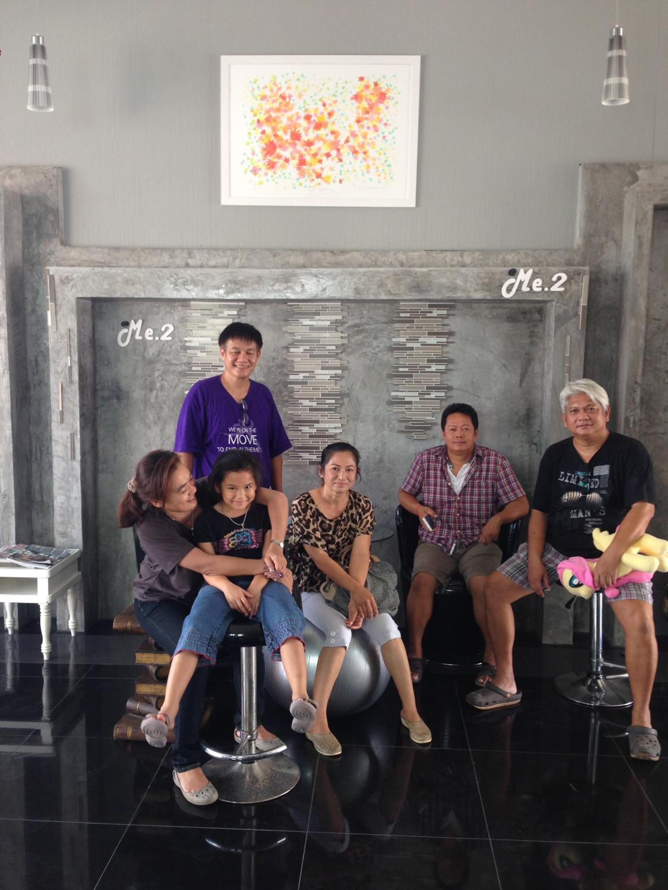 A group of people seated on exercise balls in a modern lobby with a fireplace and a framed artwork above.
