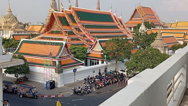 A traditional Thai temple with ornate architecture and a crowd of people in front. - Chetuphon Gate (Bangkok)