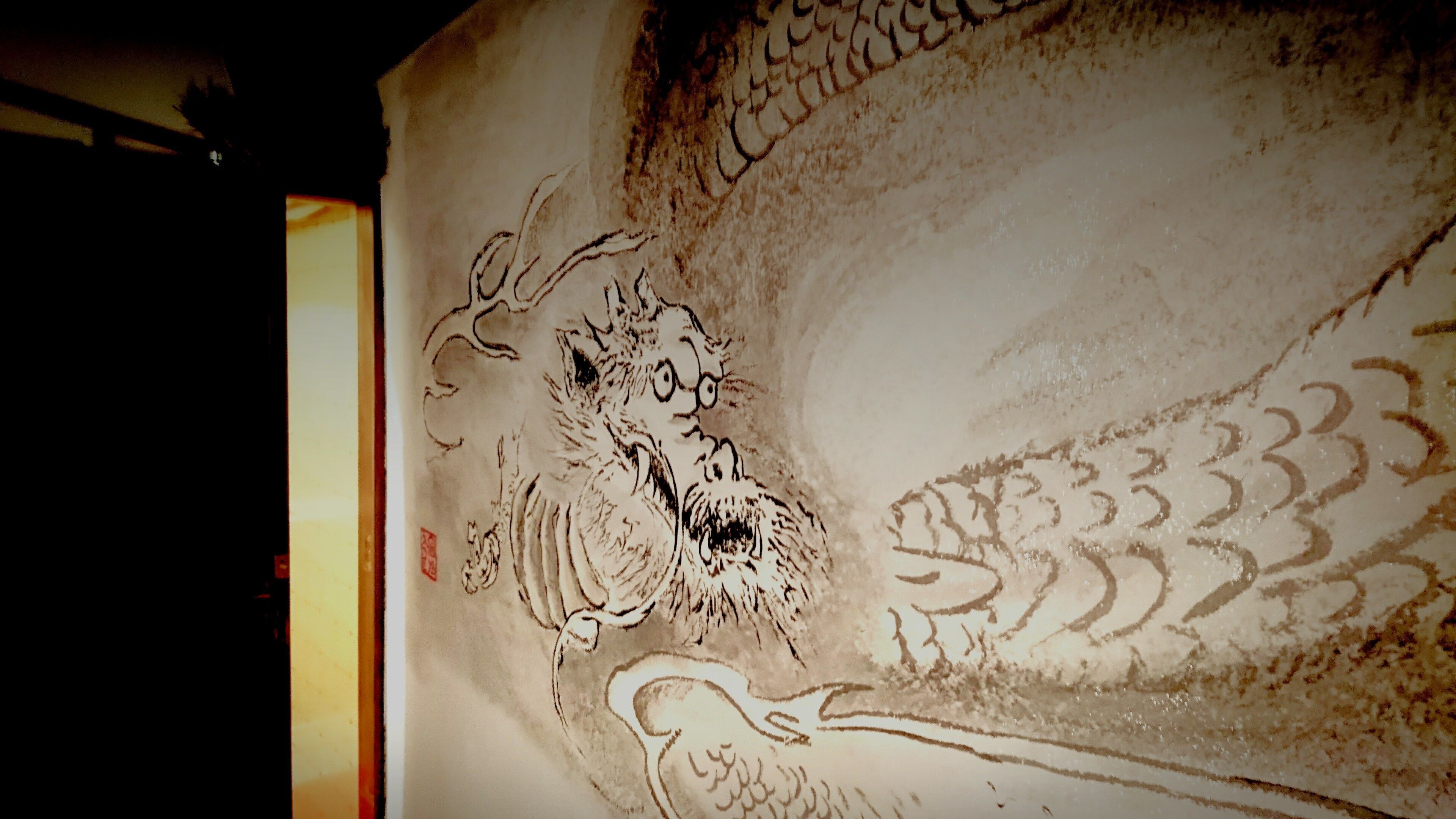 A detailed artwork with intricate patterns and figures, likely part of a larger mural or decorative panel.