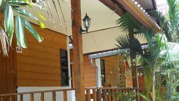 A wooden building with a balcony, a sign indicating room number A4, and a lantern.