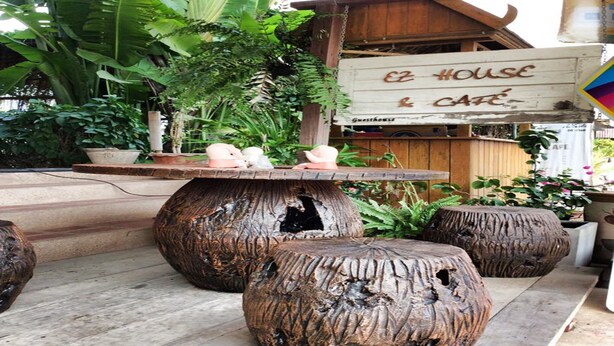 A rustic wooden structure with a sign reading "EZ HOUSE & CAFE". - EZ House & Cafe (Sukhothai)