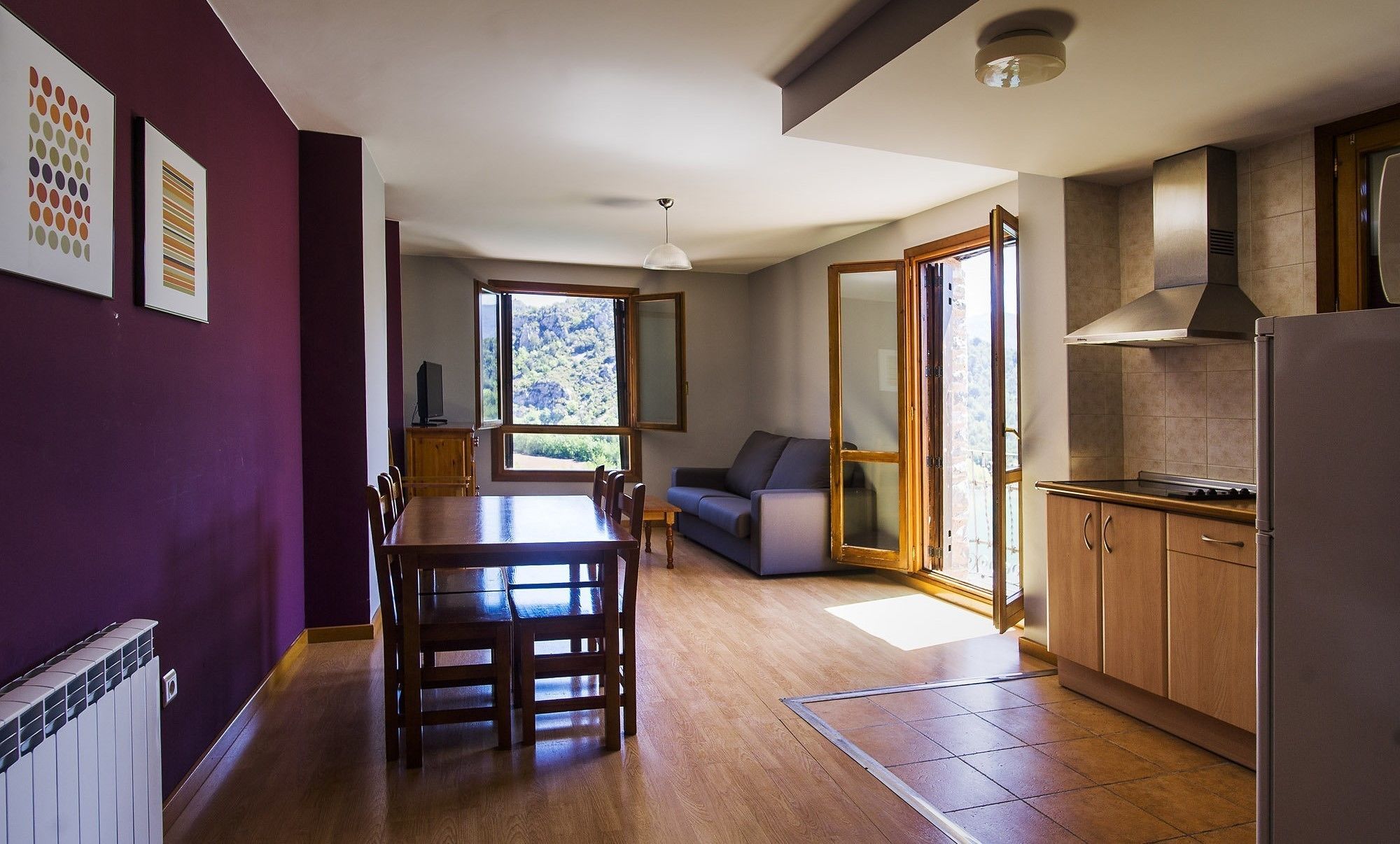 A modern kitchen with wooden cabinets, a built-in oven, and a refrigerator.