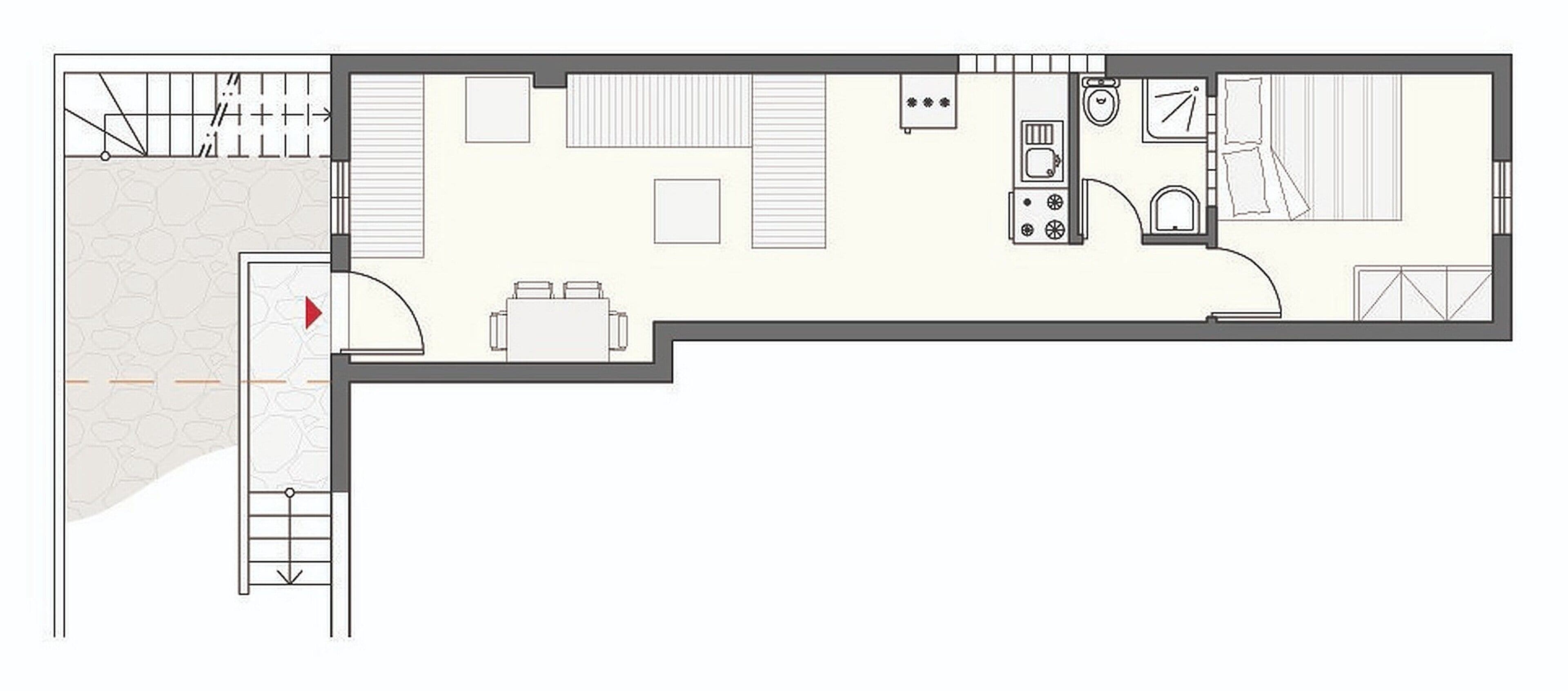 Un plan d’étage d’une chambre d’hôtel comprenant un lit, un bureau, une salle de bain et une kitchenette.