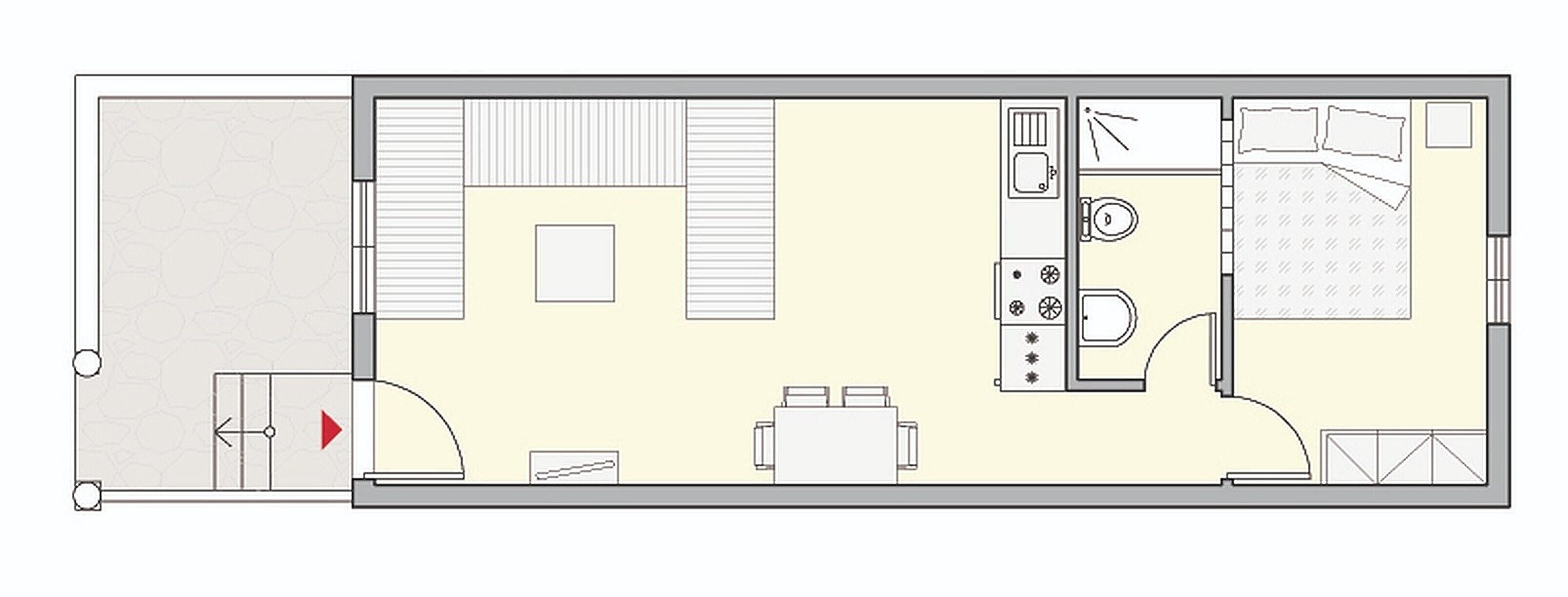 Grundriss eines Hotelzimmers mit Bett, Schreibtisch, Stuhl, kleinem Tisch, Kleiderschrank und Badezimmer.