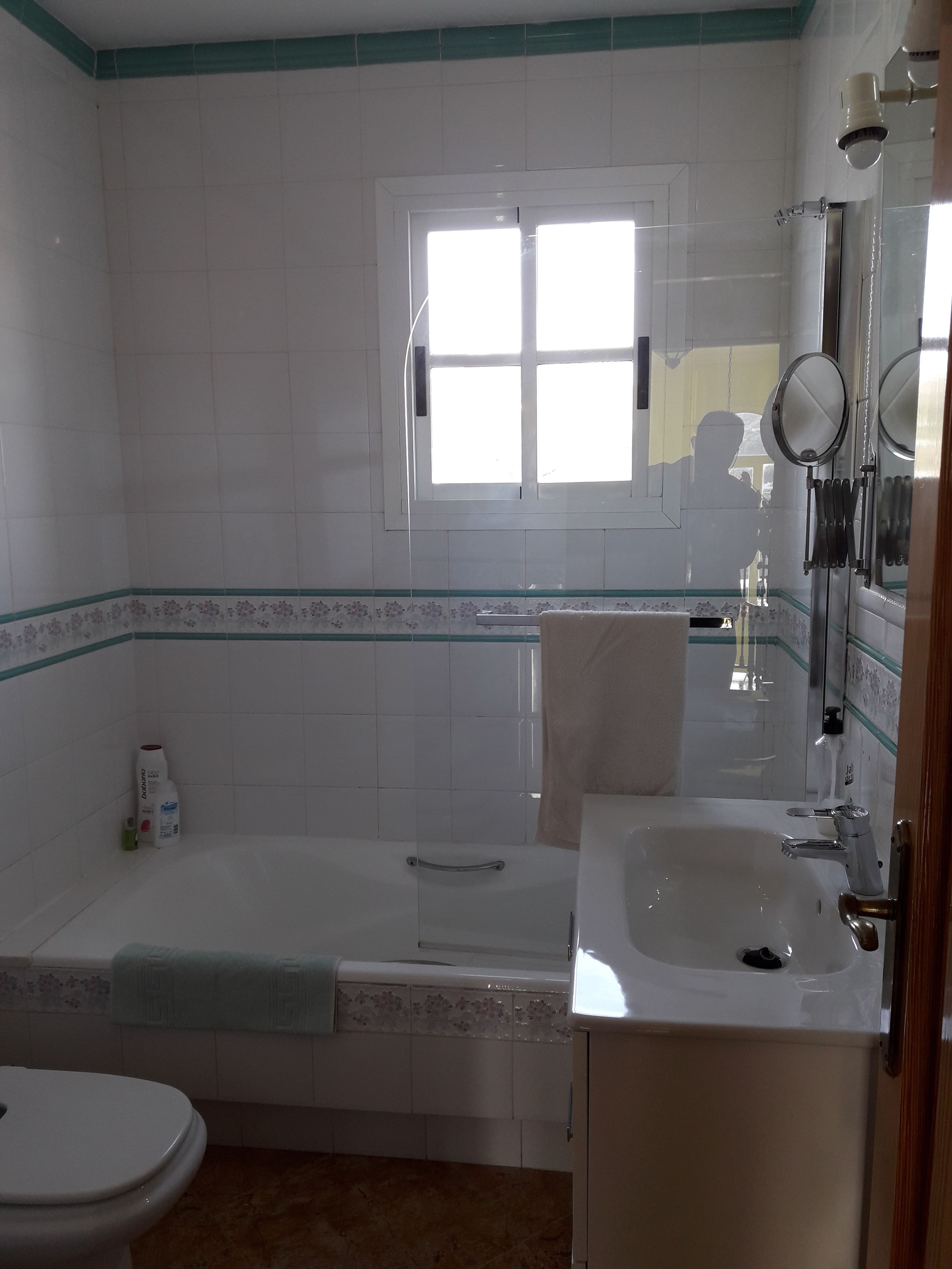 Un baño con bañera, lavabo e inodoro.
