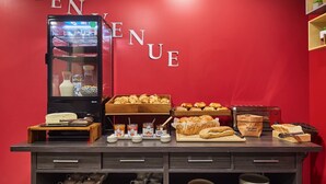 A breakfast buffet with pastries, bread, and condiments. - Appart'hôtel Odalys City Campus - Paris Rueil Malmaison (Rueil-Malmaison)