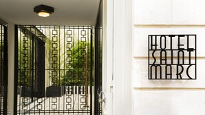 A hotel entrance with a metal gate and a sign reading "HOTEL SANT MARC". - Hotel Saint-Marc (Paris)
