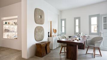 Enjoy a stylish space with a large dining table, console table, and abstract art piece.
