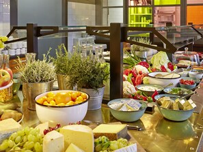 Enjoy a spread of fresh fruits, cheeses, and vegetables, accompanied by a selection of condiments and sauces.