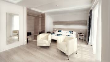 Un dormitorio moderno con una cama grande, dos sillones blancos, un vestidor y un espejo amplio.
