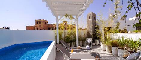Piscine extérieure, parasols de plage, chaises longues