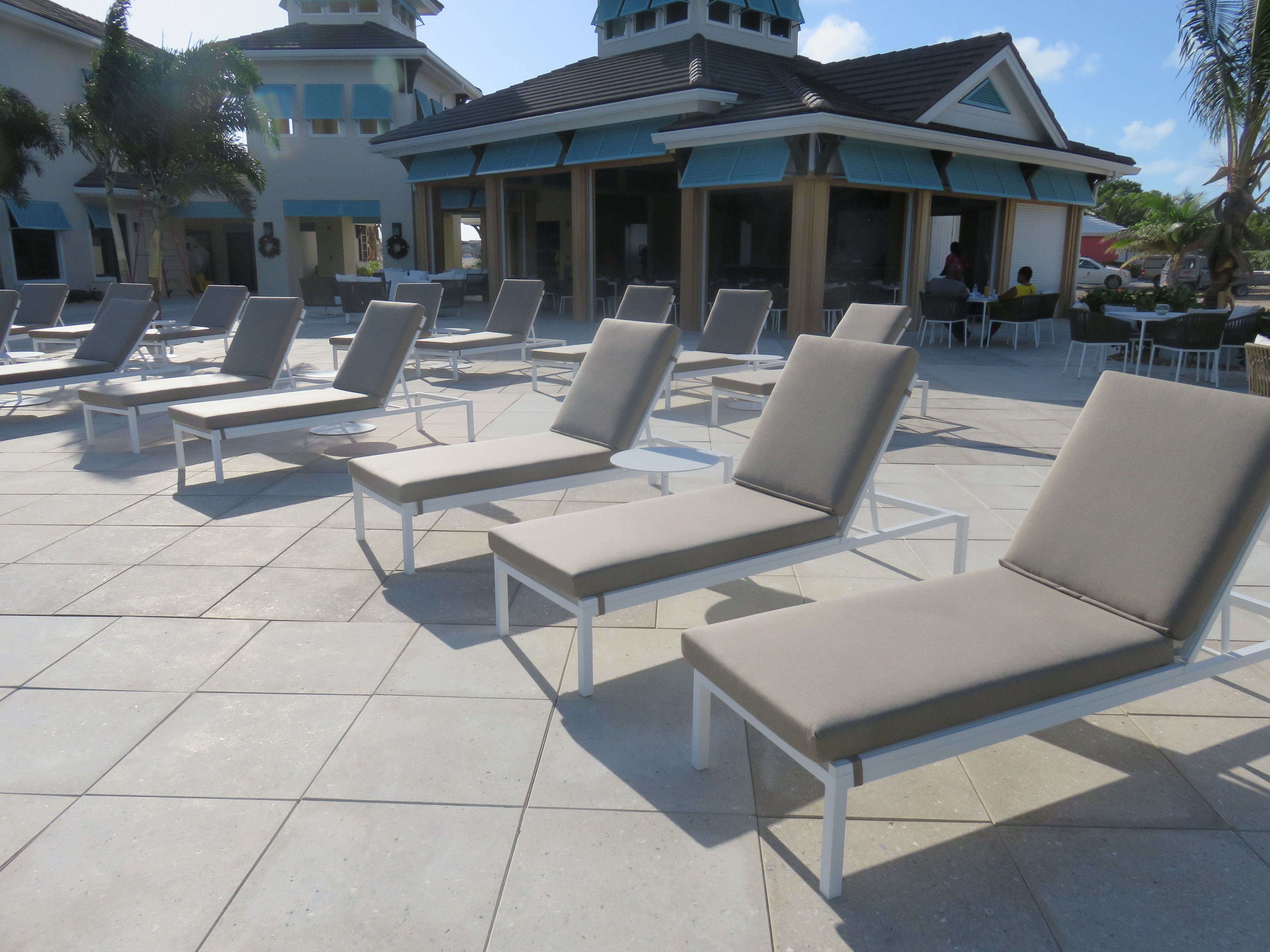 A poolside area with sun loungers and a covered seating area.