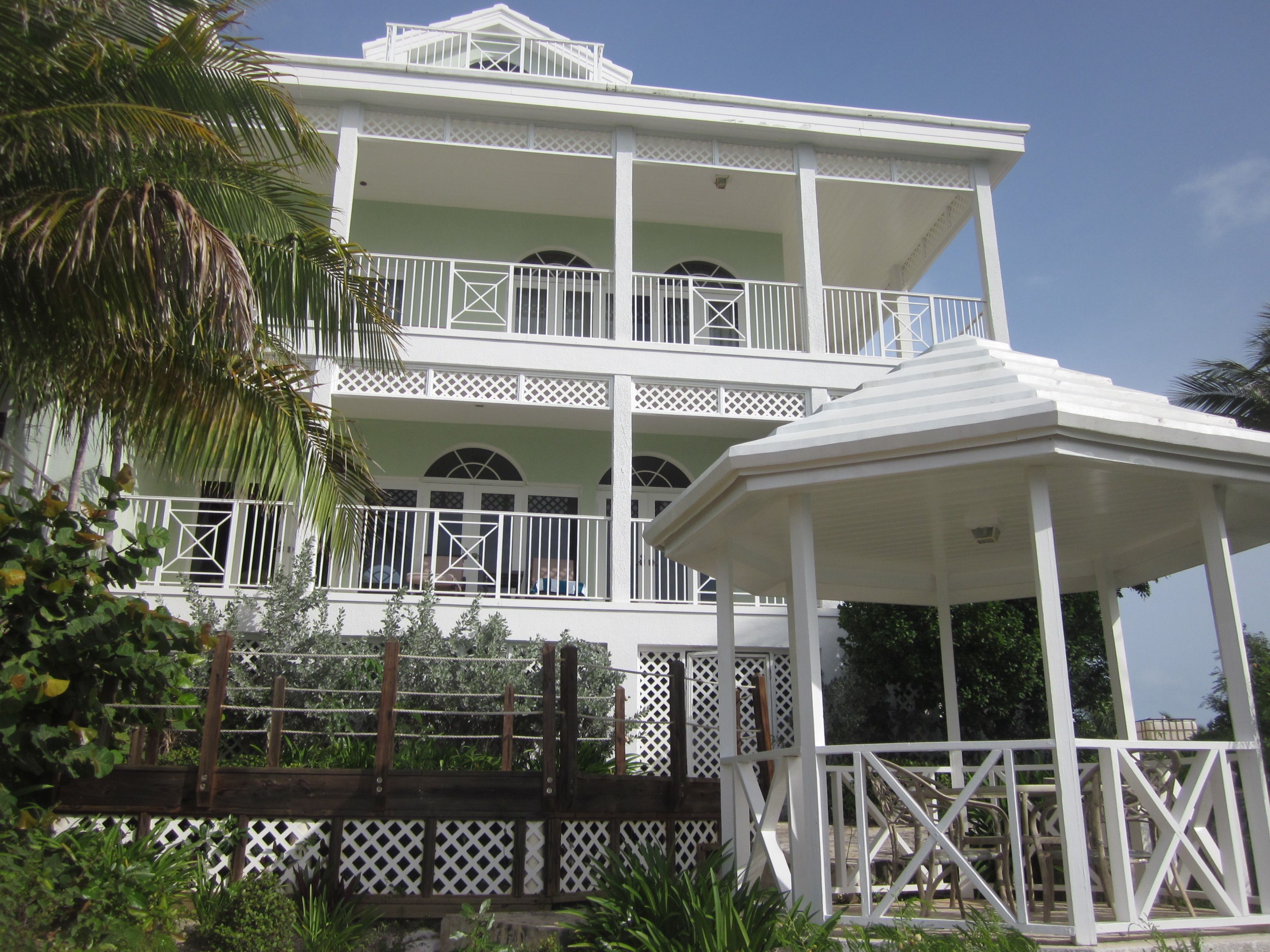 A two-story building with a balcony and a gazebo.