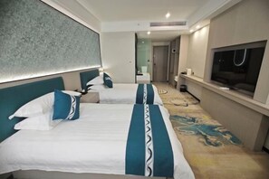 A hotel room with two beds, a TV, and a bathroom visible in the background. - Jinmao International Hotel (HUAINAN)