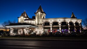 A large, historic building with multiple towers and a prominent entrance.
